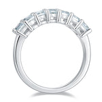 CARISSIE emerald cut moissanite wedding band, front view showing continuous row of rectangular stones in dual-prong setting