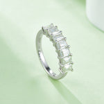 CARISSIE emerald cut moissanite ring, vertical angle showcasing the interior band stamping and prong security details