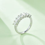 CARISSIE half-eternity moissanite band, side profile view displaying the curved arrangement of stones and polished silver metal