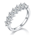 CARISSIE pear moissanite eternity band, angled view showing seven prong-set stones and polished silver-tone metal