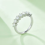 CARISSIE pear moissanite eternity band, side angle on mint green background emphasizing the stone height and band thickness