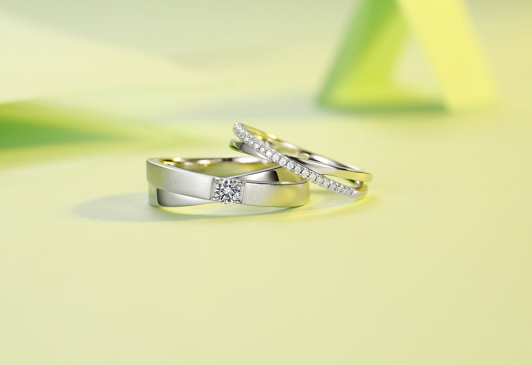 CARISSIE round moissanite pavé eternity band set, stacked arrangement on yellow surface emphasizing modern textures