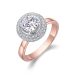 CARISSIE round moissanite halo engagement ring, rose gold version featuring a warm-toned band with classic double halo setting