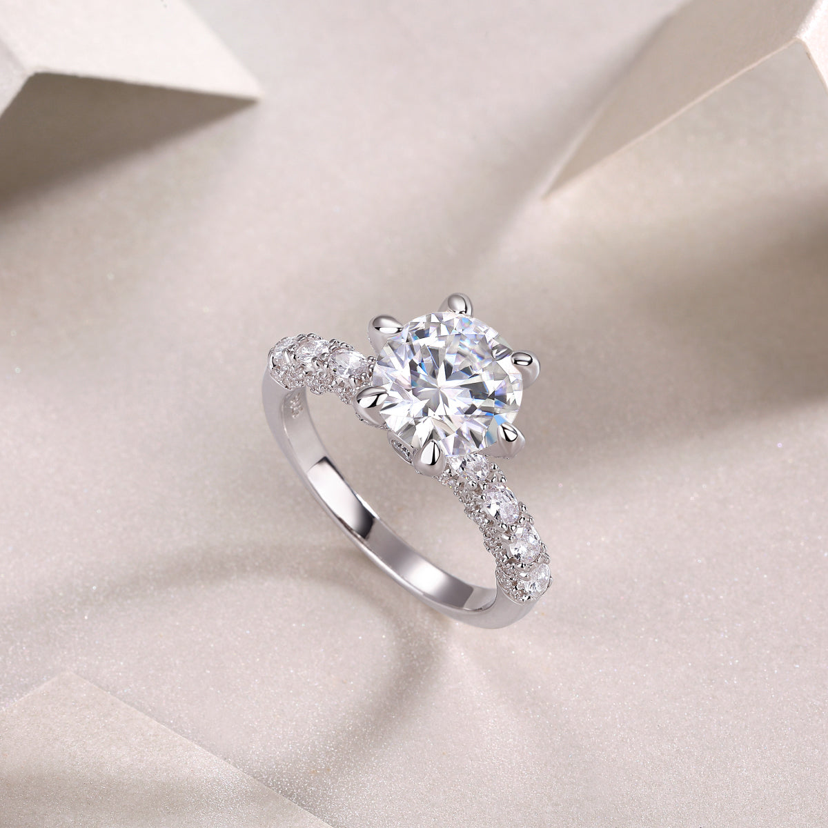CARISSIE round moissanite solitaire ring, diagonal angle emphasizing the height of the prongs and smooth shank finish