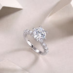 CARISSIE round moissanite solitaire ring, diagonal angle emphasizing the height of the prongs and smooth shank finish
