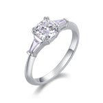 CARISSIE cushion solitaire engagement ring, angled view highlighting the 6x6mm center stone and tapered baguette side stones