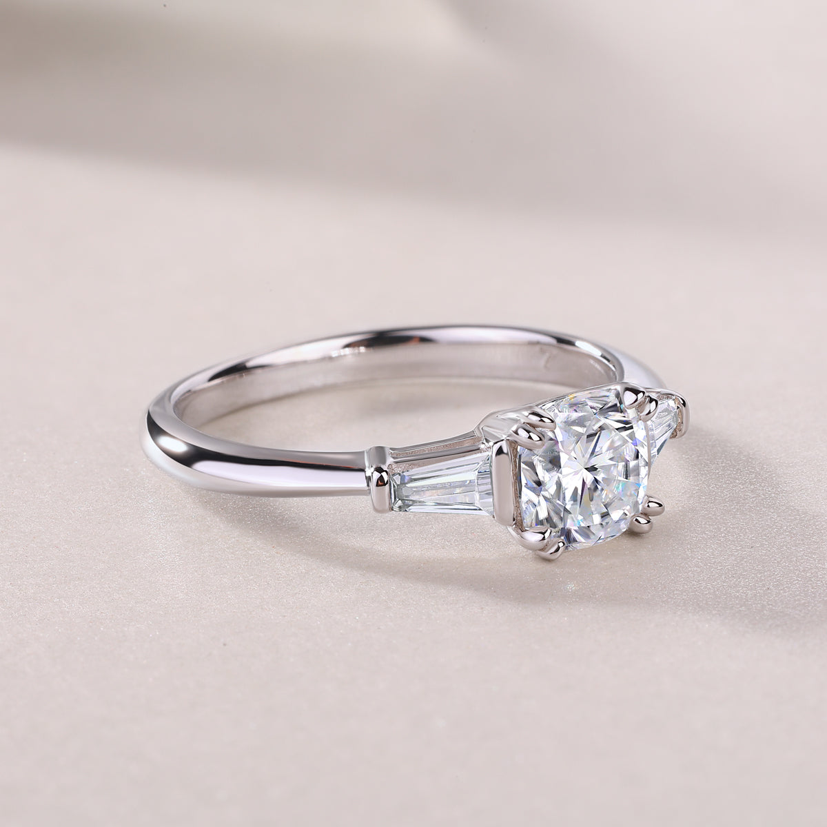 CARISSIE cushion solitaire engagement ring, low-angle close-up focusing on the sleek band transition and clear gemstone facets