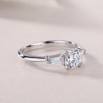 CARISSIE cushion solitaire engagement ring, low-angle close-up focusing on the sleek band transition and clear gemstone facets