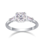CARISSIE cushion solitaire engagement ring, front view displaying the symmetrical three-stone arrangement in polished silver-tone metal