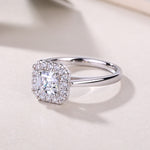 CARISSIE Asscher solitaire ring, oblique angle displaying the full circumference of the diamond halo and reflective finish of the band