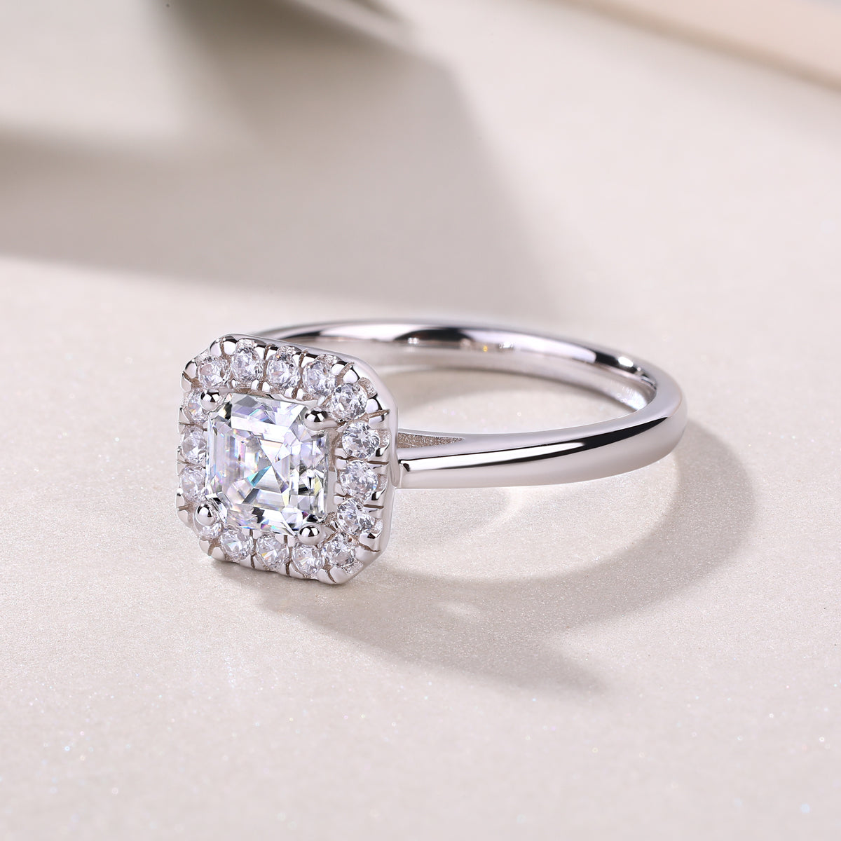 CARISSIE Asscher solitaire ring, oblique angle displaying the full circumference of the diamond halo and reflective finish of the band