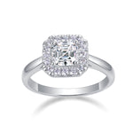 CARISSIE Asscher solitaire ring, angled view highlighting the step-cut center stone and round halo in polished silver-tone metal