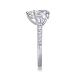 CARISSIE pear moissanite ring side profile, displaying the height of the setting and channel-set diamonds on the shank