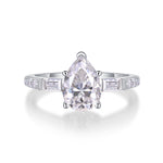 CARISSIE pear moissanite engagement ring top-down shot, showcasing the prong setting and sparkle of the center gem
