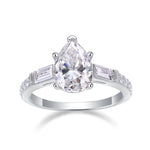 CARISSIE pear cut moissanite ring front view, featuring a brilliant center stone flanked by rectangular baguette side stones