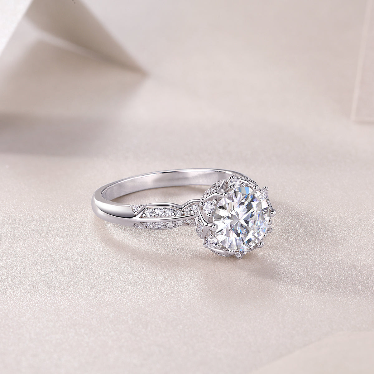 CARISSIE round moissanite halo engagement ring, diagonal angle showcasing the curve of the band and sparkle