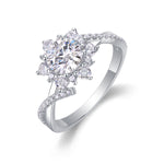 CARISSIE round moissanite halo engagement ring, angled view highlighting the twisted split shank and pavé-set accent stones