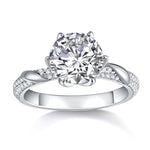 CARISSIE round moissanite solitaire ring front profile displaying symmetrical metal curves and rows of small accent stones