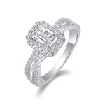 CARISSIE emerald cut moissanite halo ring close-up, angled perspective revealing pavé details on twisting silver-tone metal bands