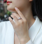CARISSIE cushion moissanite halo ring worn on hand, angled view highlighting the double halo setting and stone brilliance