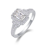 CARISSIE emerald cut moissanite halo ring angled studio shot, revealing split shank pavé band details