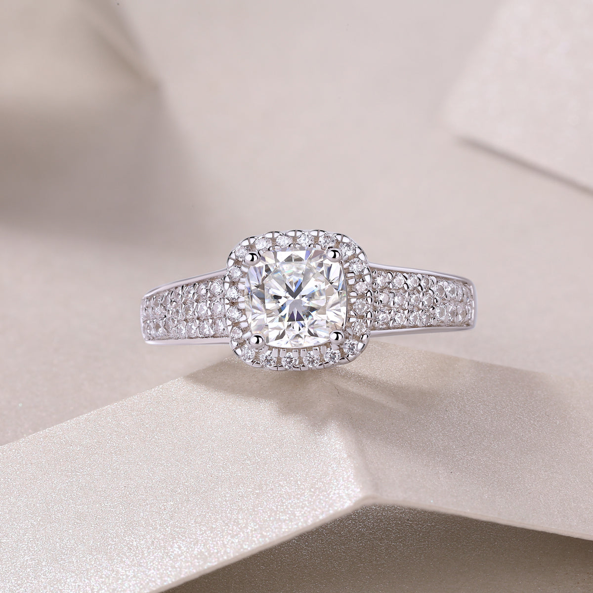 CARISSIE cushion moissanite halo wedding band top-down close-up, capturing brilliance of the 6x6mm center stone and surrounding halos