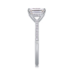 CARISSIE emerald cut ring side profile, emphasizing tall prongs, gallery details, and half-pavé diamond band