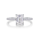CARISSIE engagement ring straight-on angle, revealing gallery accent stones beneath the elevated emerald cut center