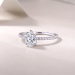 CARISSIE pear moissanite solitaire ring low-angle perspective, emphasizing the height of the prong setting