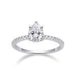 CARISSIE pear moissanite solitaire ring front view, highlighting large center stone and diamond-encrusted band