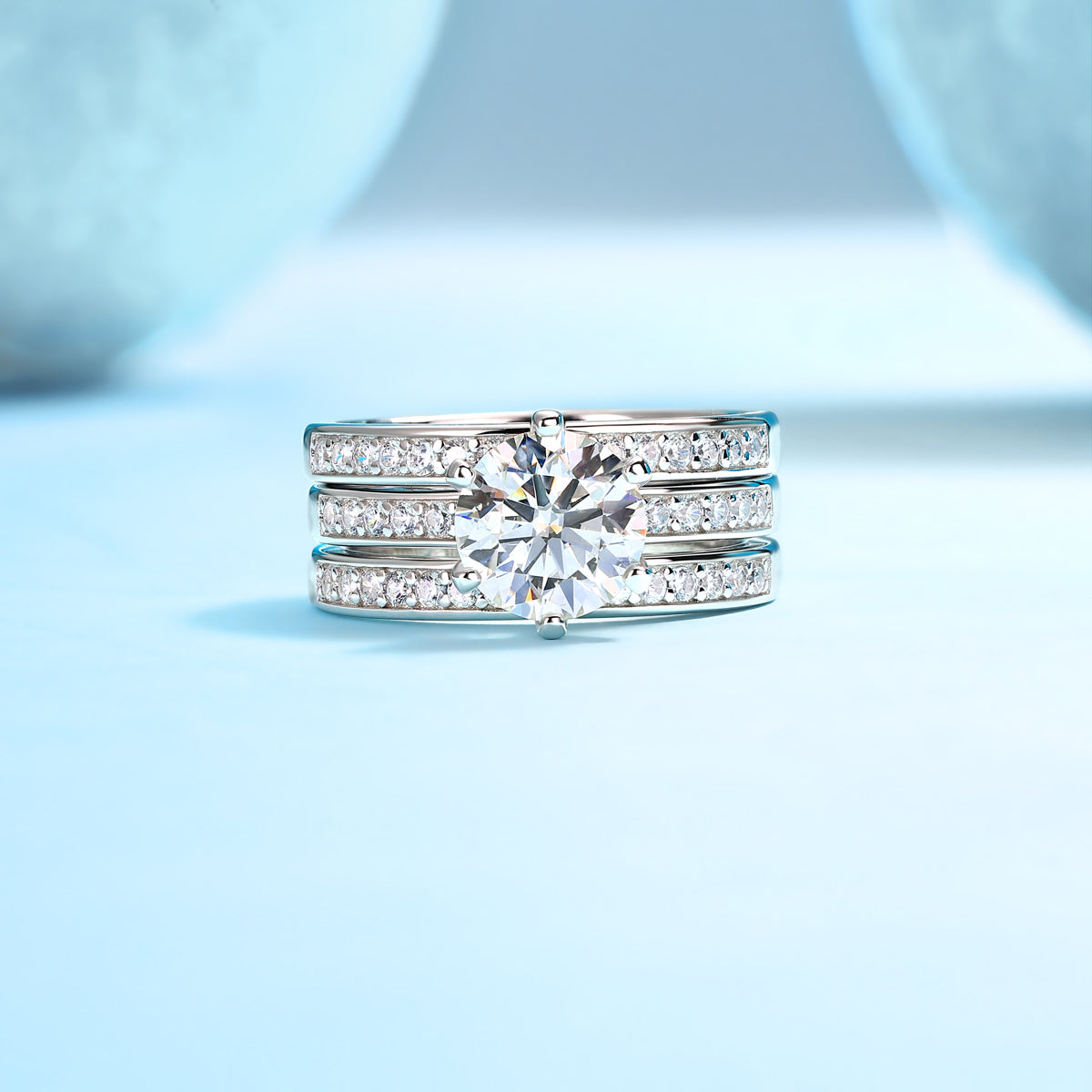 CARISSIE round moissanite solitaire ring set, direct front view emphasizing the alignment of channel-set stones
