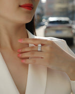 CARISSIE round moissanite solitaire ring set, lifestyle view on model with city background showing three-band design