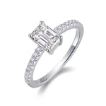 CARISSIE 5x7mm emerald cut ring angled view, showcasing silver-tone metal and pavé-set accent stones