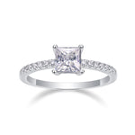CARISSIE princess solitaire ring front view, showcasing symmetrical square cut stone and sparkling side stones
