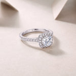 CARISSIE round moissanite ring angled view, displaying polished white gold band and side stone details