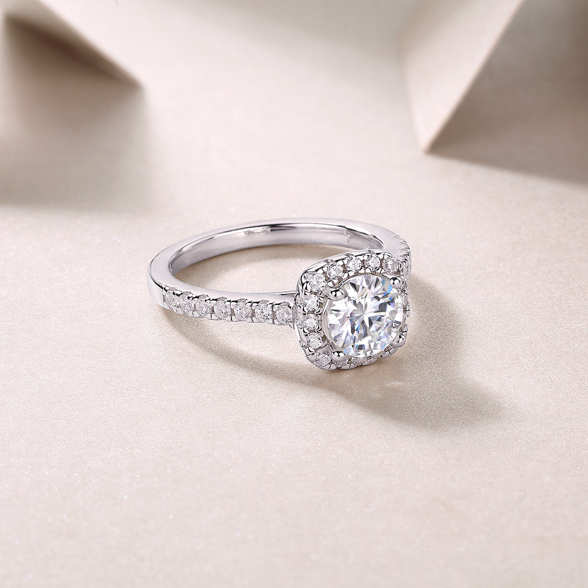 CARISSIE round moissanite ring angled view, displaying polished white gold band and side stone details