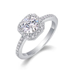 CARISSIE moissanite engagement ring angled view, displaying brilliant cut center stone, sharp octagonal halo, and diamond-studded band
