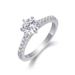 CARISSIE round moissanite solitaire ring, angled view showing six prong setting and pavé diamond band