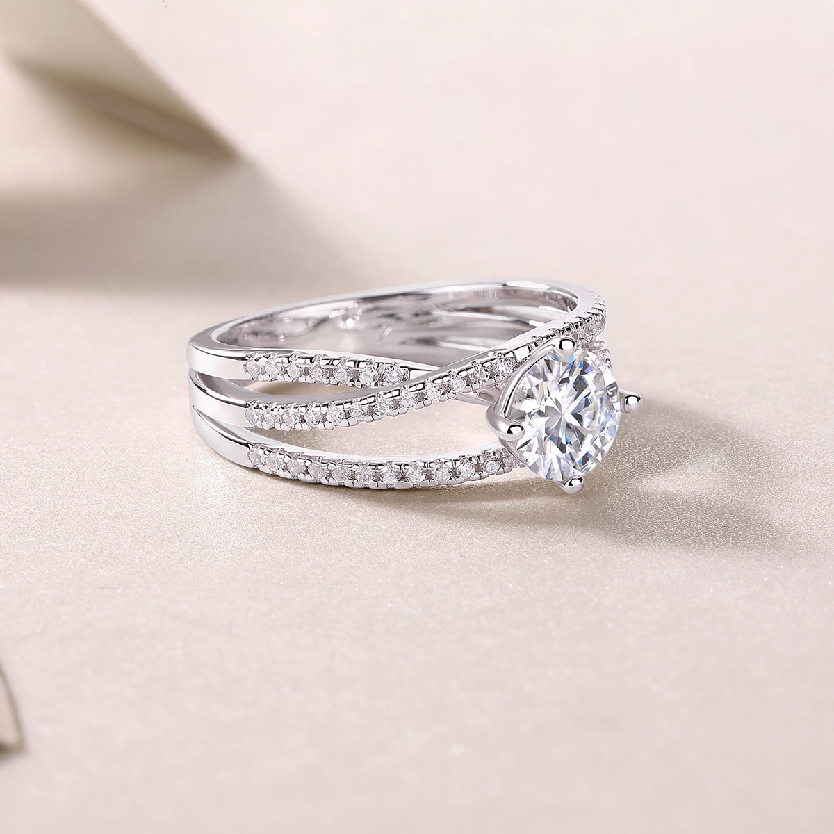 CARISSIE round moissanite solitaire ring angled side view, showing three-strand band structure and gemstone profile
