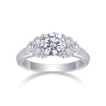 CARISSIE round moissanite solitaire ring, front view showcasing the brilliant center stone surrounded by a halo of smaller gems