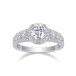 CARISSIE round moissanite solitaire ring, front view highlighting the brilliant center stone surrounded by a pavé halo