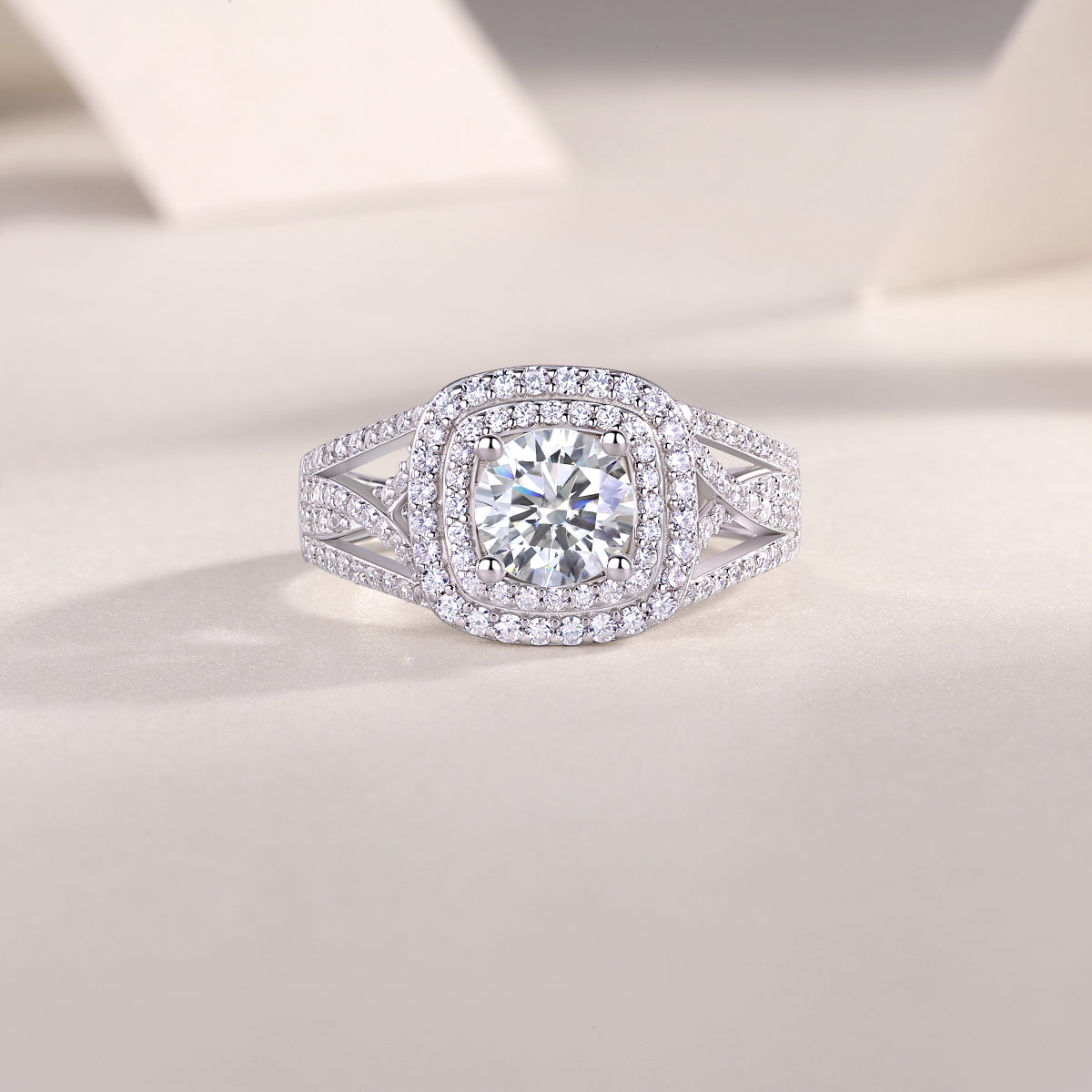 CARISSIE round moissanite solitaire ring, lifestyle shot on textured surface emphasizing luxurious sparkle