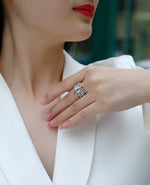 CARISSIE oval moissanite solitaire ring, lifestyle shot featuring wide pavé band and intricate lattice metalwork on model