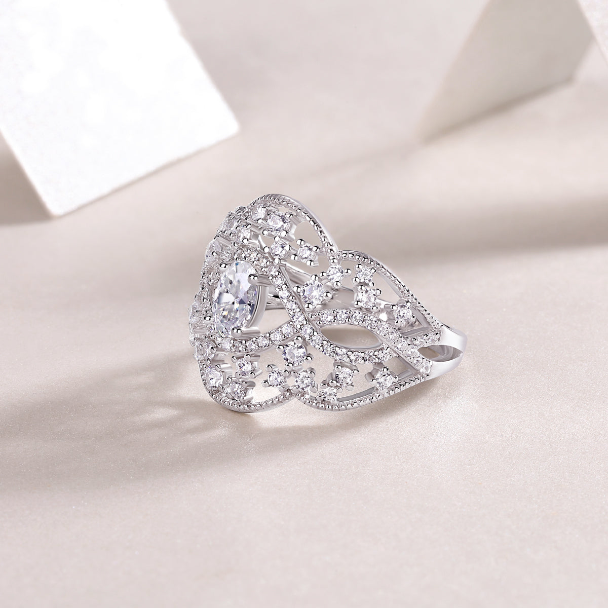 CARISSIE oval moissanite solitaire ring, oblique angle view capturing the depth of the filigree work and stone brilliance