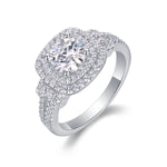 CARISSIE round moissanite halo ring, angled view highlighting the double square halo and split shank pavé band