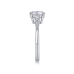CARISSIE round moissanite engagement ring, side profile revealing the tapered metal shank and vertical alignment of accent stones