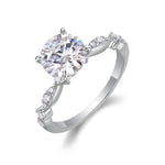 CARISSIE round moissanite solitaire ring, angled view highlighting brilliant center stone and marquise shoulder accents