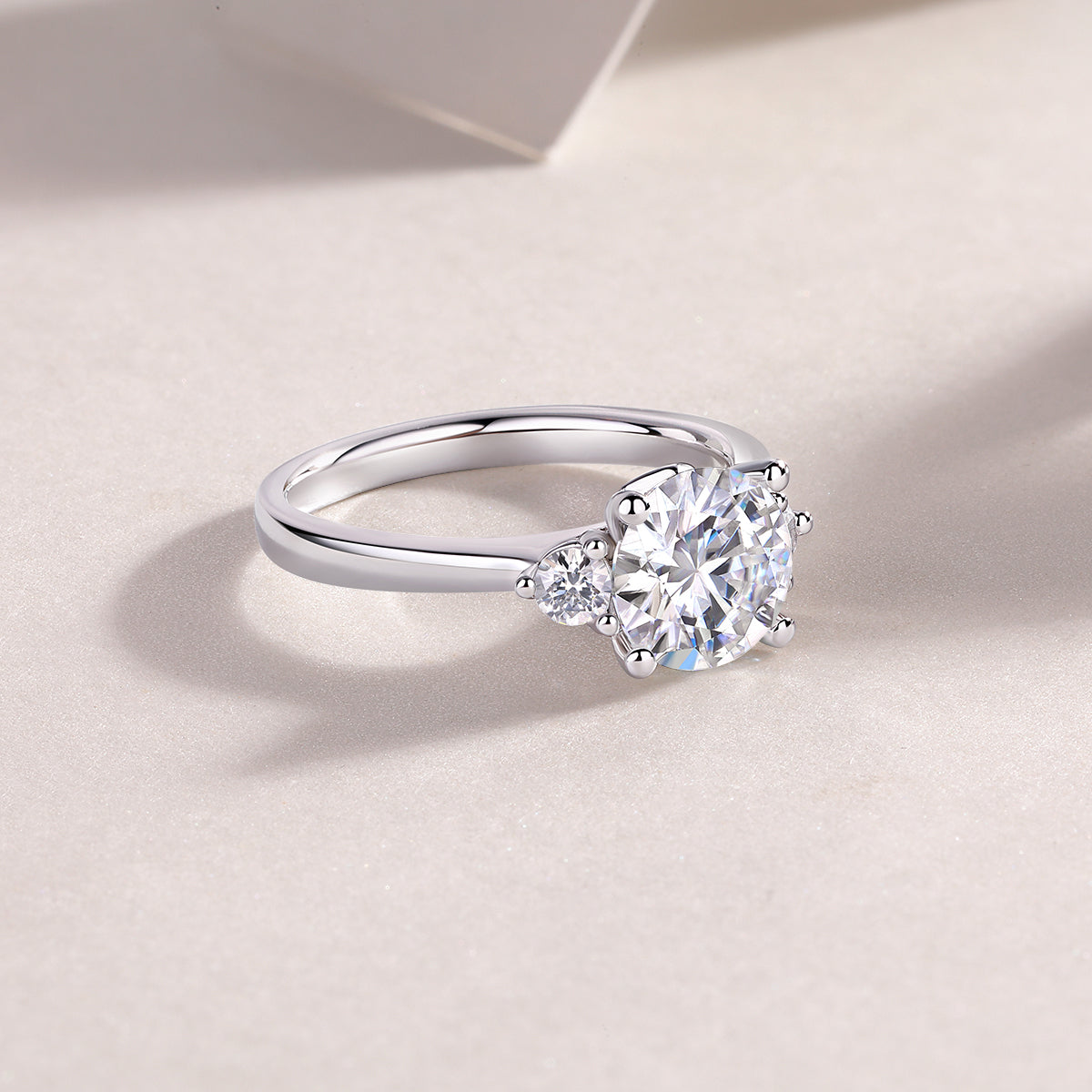 CARISSIE engagement ring lifestyle shot, resting on white background to showcase the elegant curve of the metal band