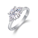 CARISSIE round moissanite engagement ring, angled view showing large center stone and side stones in polished silver setting