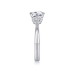 CARISSIE round moissanite solitaire ring, top-down side angle displaying vertical prong height and shoulder stone arrangement